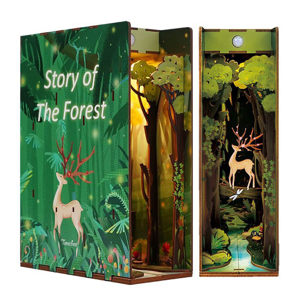 An open book nook titled "Story of The Forest," revealing a layered diorama of a forest with a deer and stream