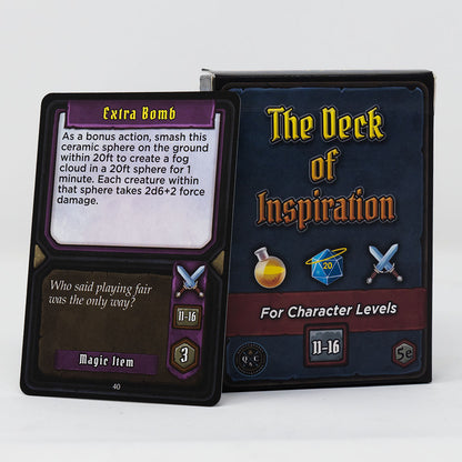 A game card titled "Extra Bomb" leans against its box, "The Deck of Inspiration,",