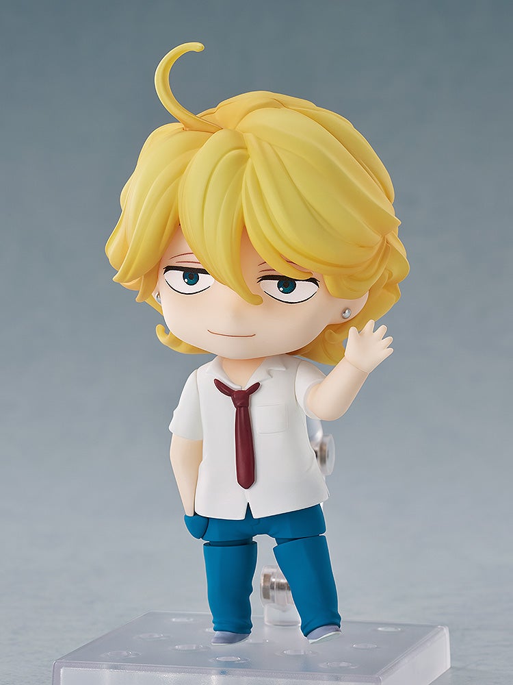 Blond Nendoroid anime figure in a white shirt, red tie, and blue pants, smirking and waving