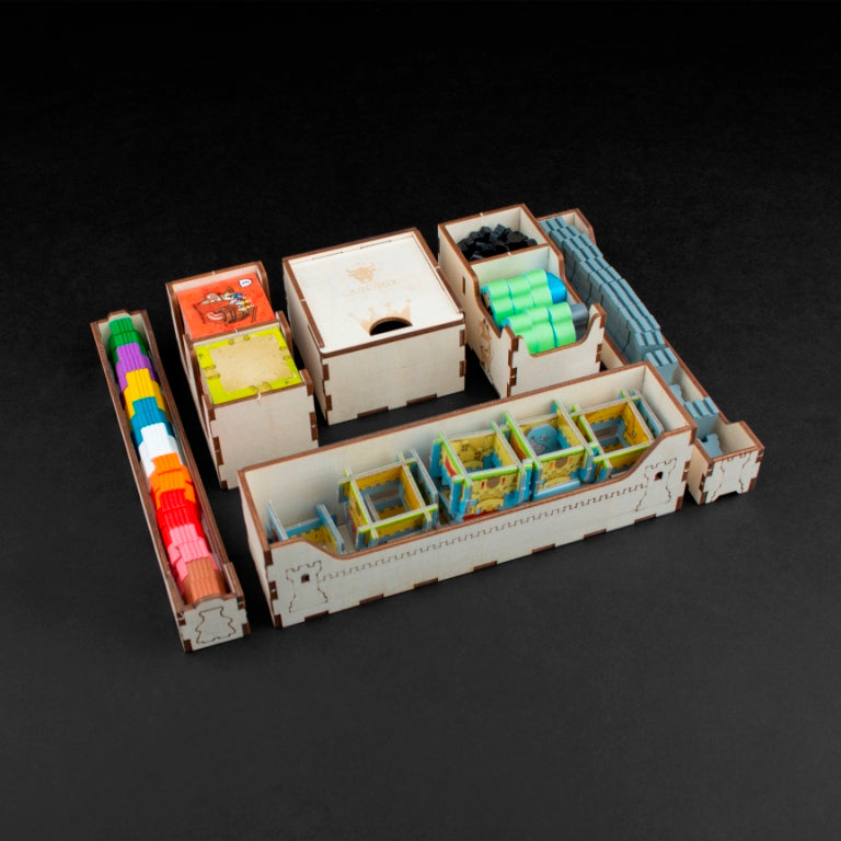 Neatly arranged Kingdomino tiles in Laserox wooden game insert