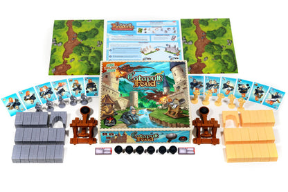 Full Catapult Feud board game components laid out: box, playmats, cards, two catapults, castle walls, and figures