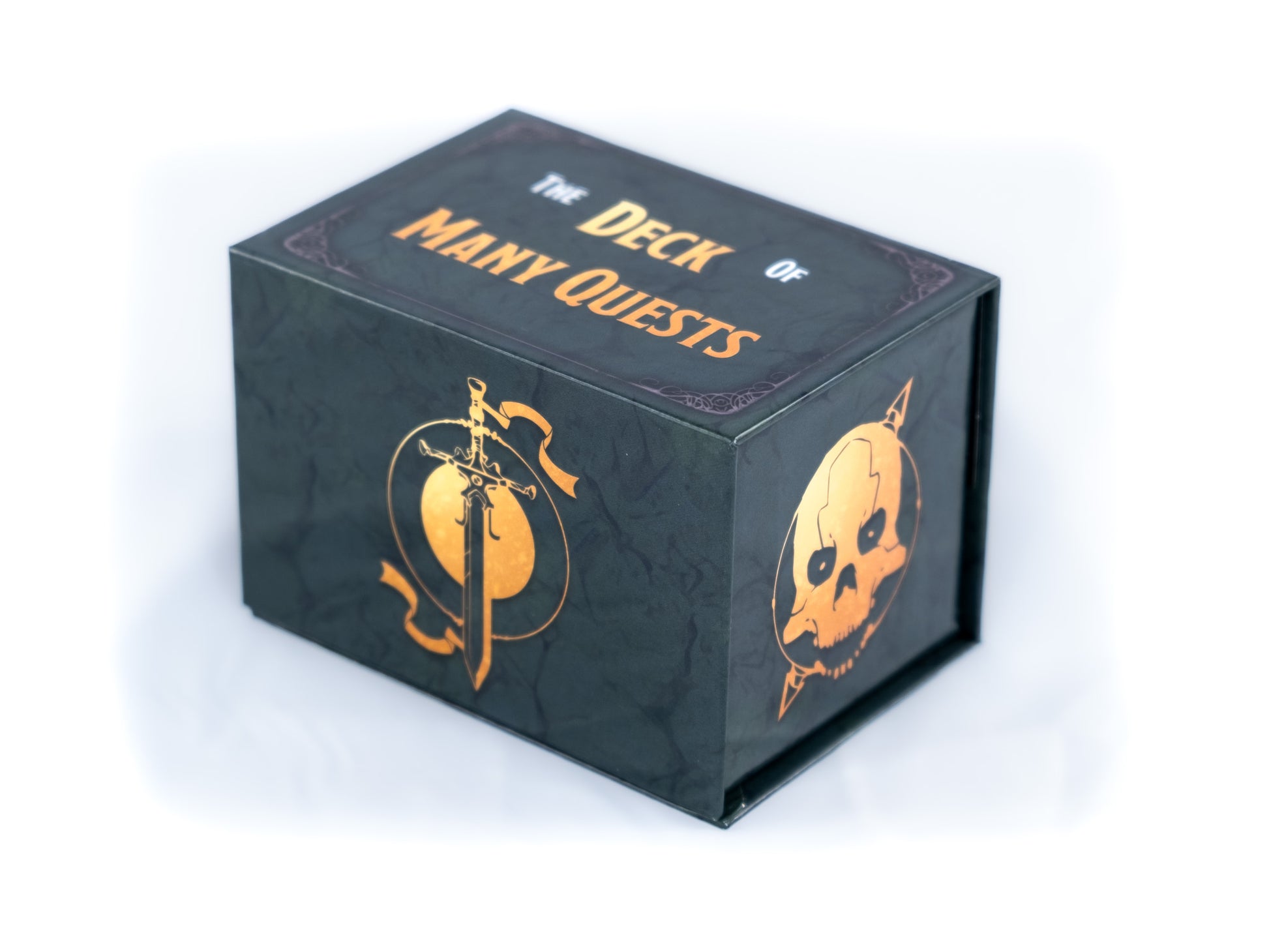 Game box for "The Deck of Many Quests," dark with gold foil lettering and fantasy skull/sword art