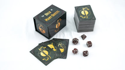 Tabletop game components: "Deck of Many Quests" box, stacked cards, and metal polyhedral dice