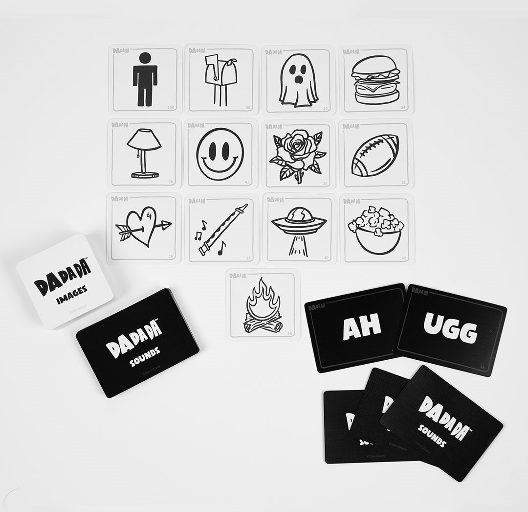 DaDaDa game cards laid on white. White image cards feature black line art (ghost, burger); black sound cards display text (AH, UGG)