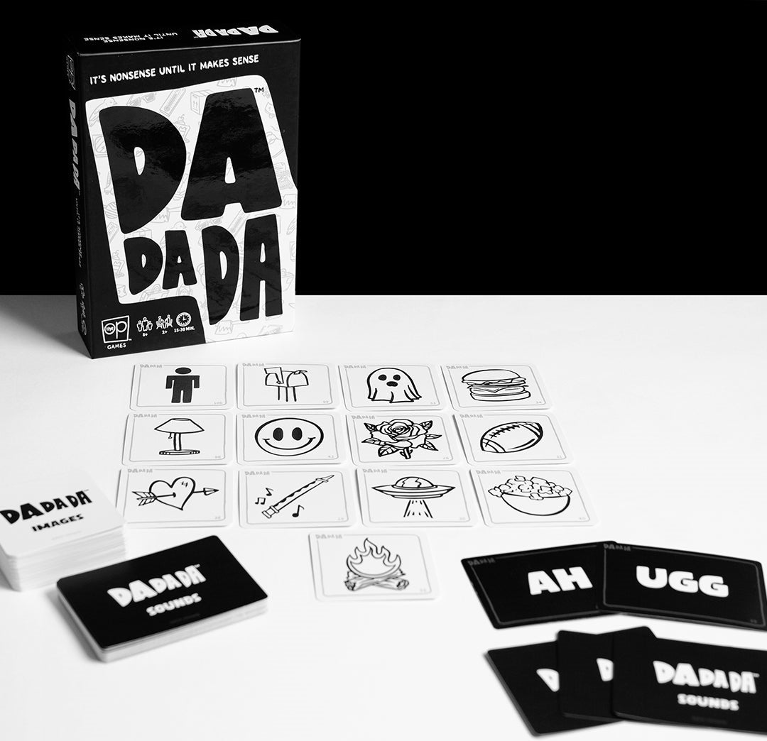 Black and white photo of the 'DaDaDa' card game, with its box, white image cards (ghost, burger), and black sound cards laid out
