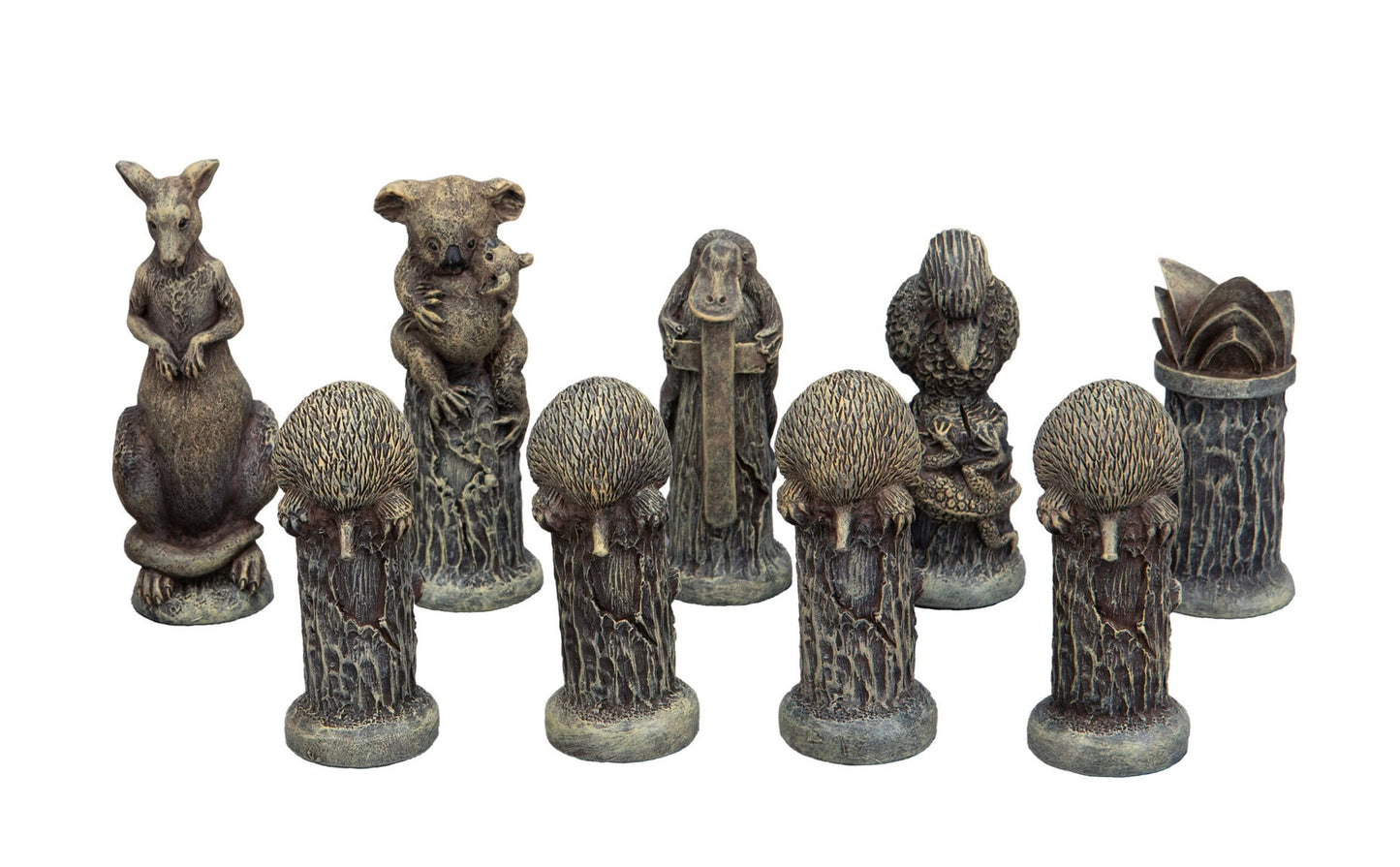 Collection of weathered figurines depicting Australian animals: kangaroo, koala with joey, platypus, lizard, and echidnas
