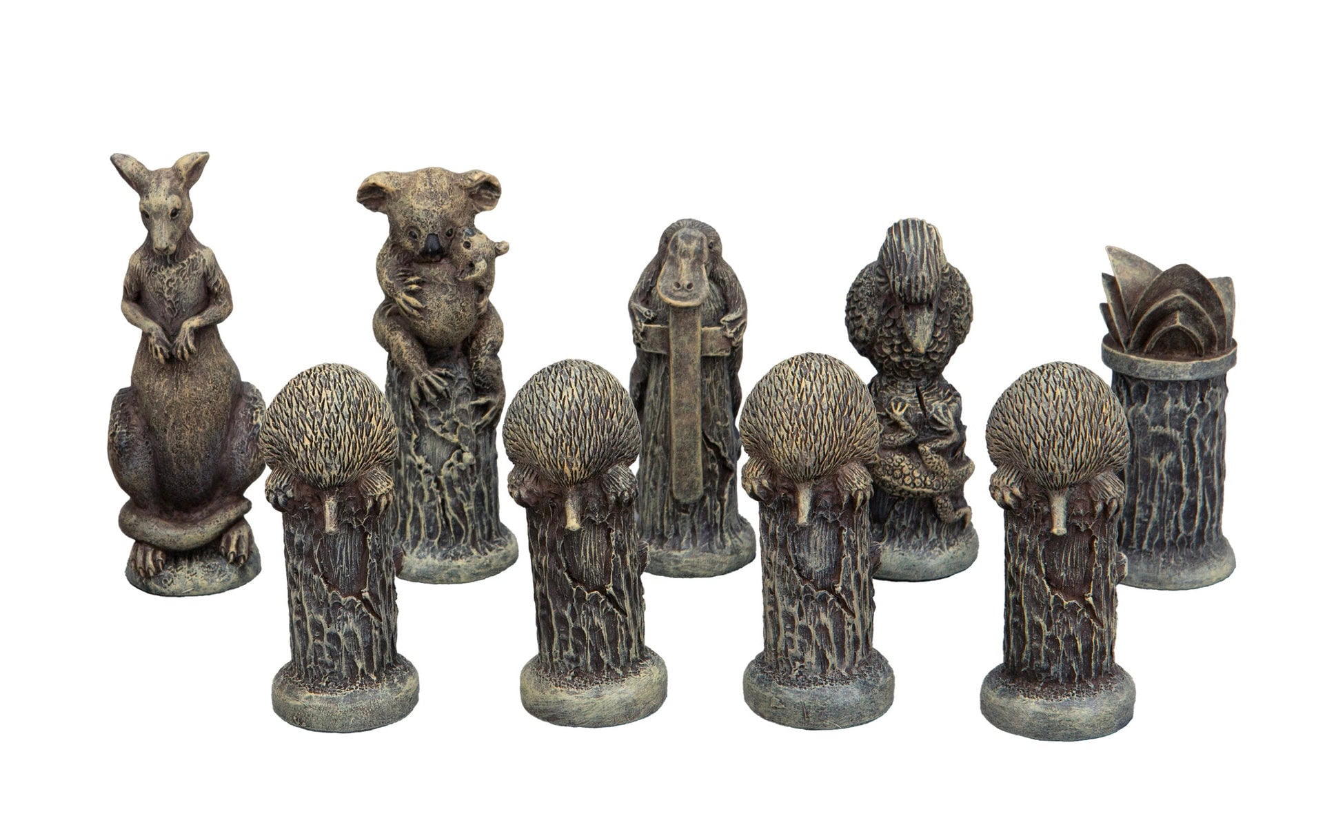 Collection of weathered figurines depicting Australian animals: kangaroo, koala with joey, platypus, lizard, and echidnas