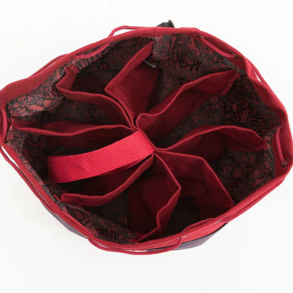 Open red drawstring dice bag with eight interior compartments and a dark patterned lining