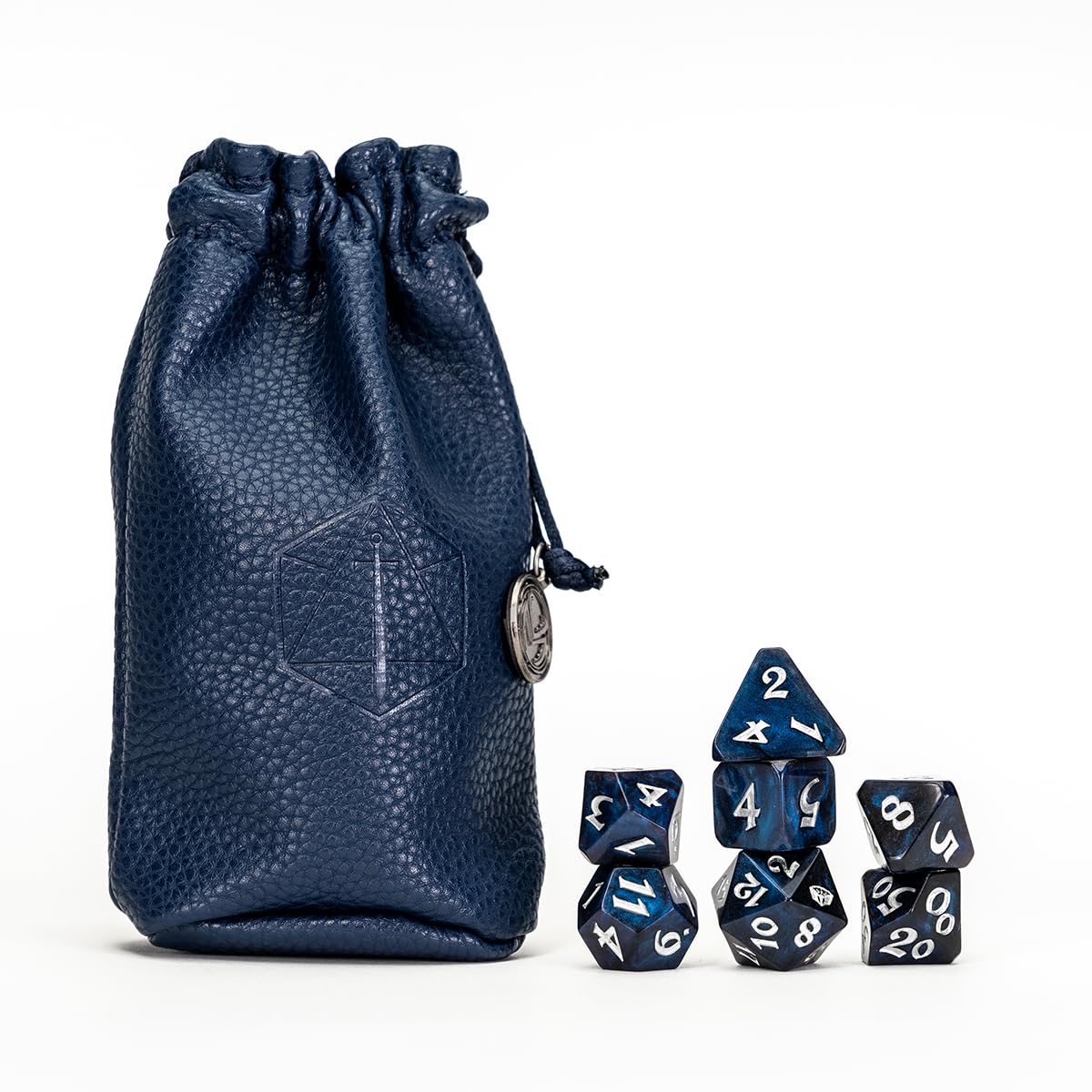 Dark blue pebbled leather dice bag with an emblem and metal charm, next to stacked blue polyhedral dice with white numbers