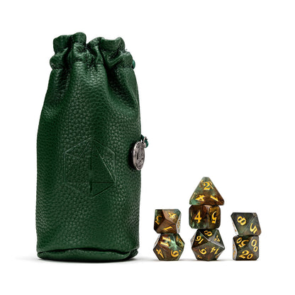Dark green textured dice bag with silver charm, beside a full set of green and gold marbled polyhedral RPG dice