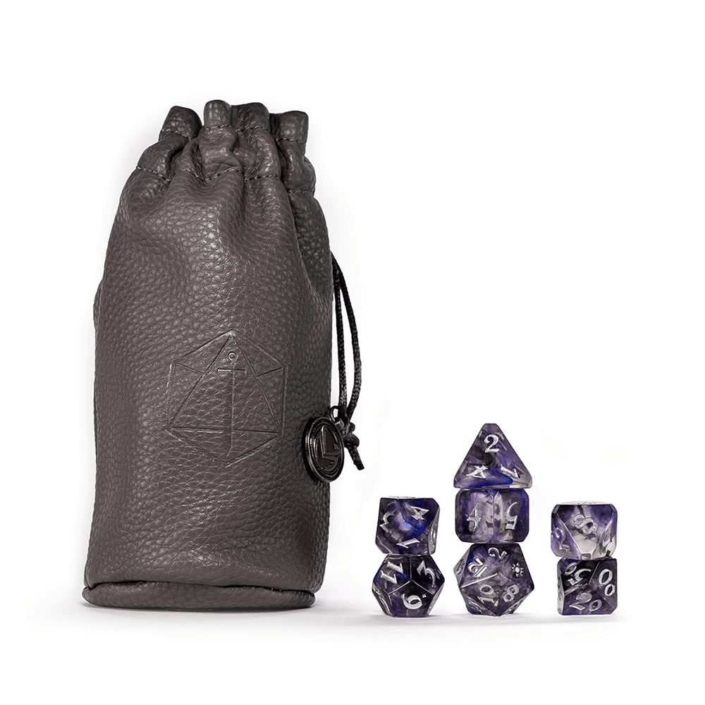 A grey leather dice bag with an emblem, beside 7 stacked, marbled purple polyhedral RPG dice