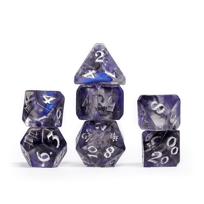 Seven translucent blue and clear swirled polyhedral dice, stacked in columns
