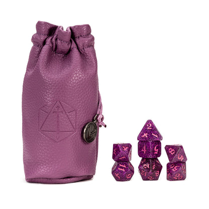 Purple leather dice bag with logo, beside stacked glittery purple polyhedral game dice
