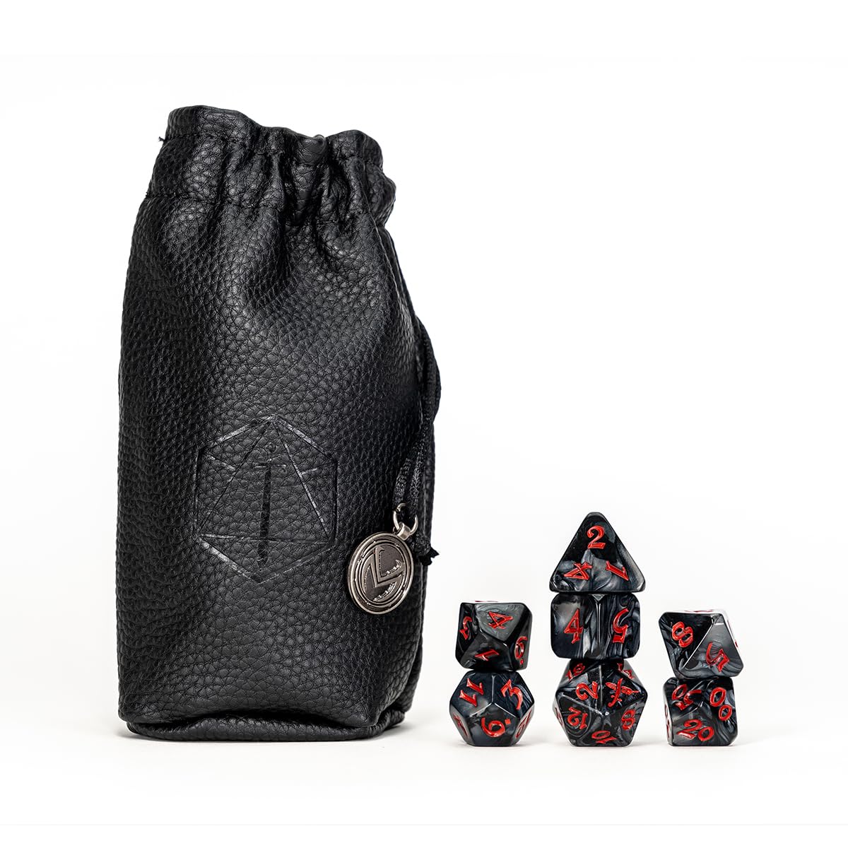 Black leather dice bag with an embossed logo and metal charm, next to marbled black polyhedral dice with red numbers.