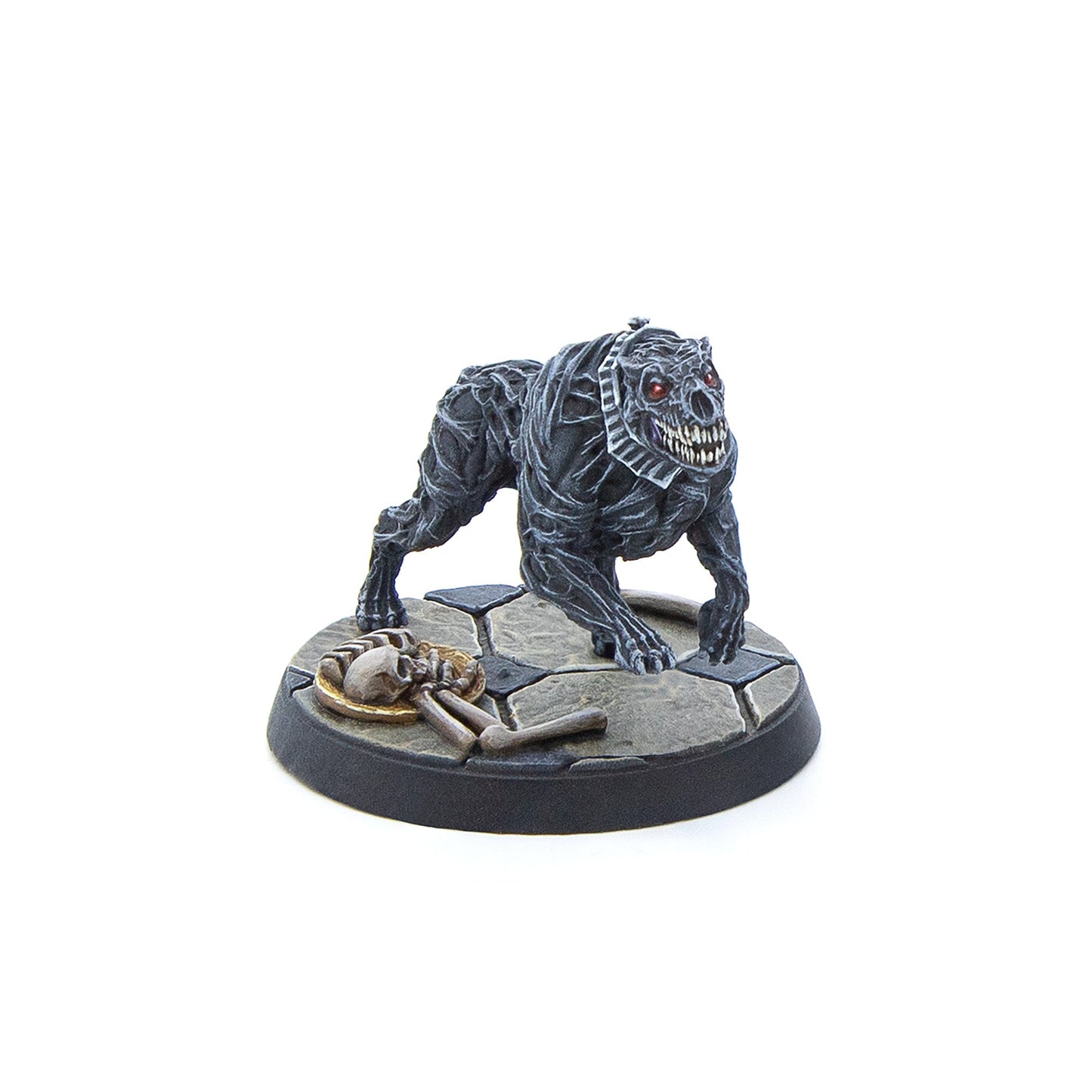 Dark grey monstrous dog miniature with red eyes, sharp teeth, crouching near a skeleton on a stone base