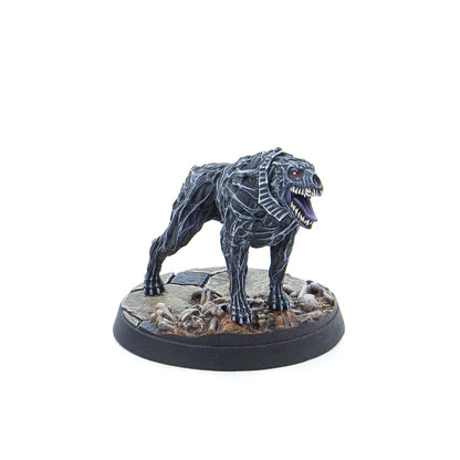 Miniature: Dark grey, emaciated dog-like monster with red eyes and a snarling open mouth, standing on a rocky base with bones