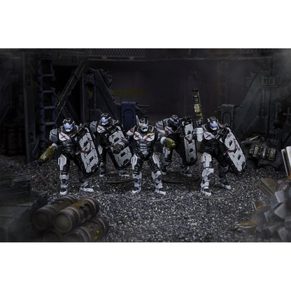 Five futuristic armored miniatures with white/black armor, chest X-marks and shields stand in a dark, industrial scene.