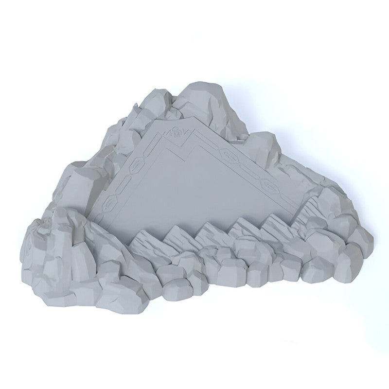 A grey triangular Dice Miner Deluxe recycled plastic mountain with etched border details, embedded in rugged rocks