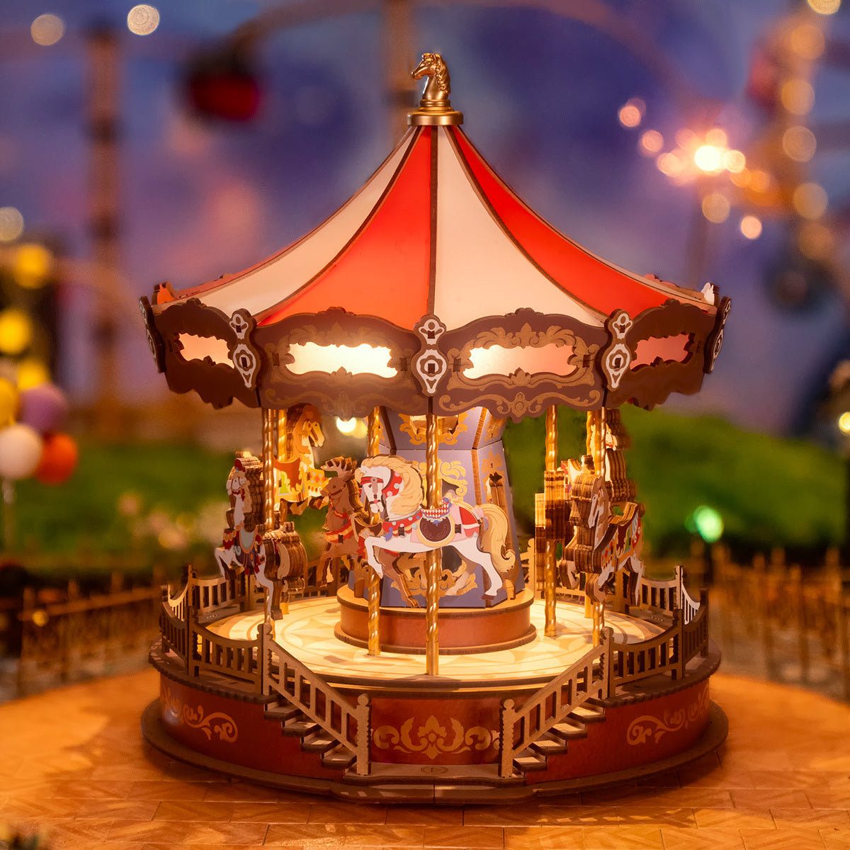 A glowing, detailed miniature wooden carousel with red and white stripes and horses, against a blurry night scene