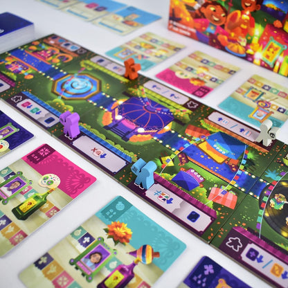 Festive board game with a vibrant path, fountain, and market stalls, colorful meeples in purple, orange, blue, and white are on the board, surrounded by cards with portraits, bottles, and sugar skulls
