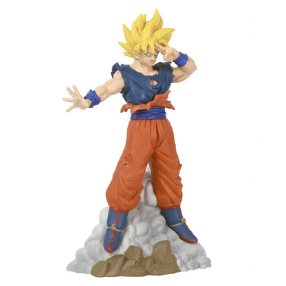 Super Saiyan Goku figure with torn blue top, orange pants, right hand to temple, on a cloud and rock base