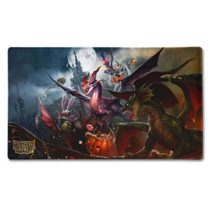 Halloween night with dragons and creatures around a candy-filled pumpkin, a spooky castle under a full moon