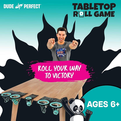 Dude Perfect's Coby points at the "Tabletop Roll Game" featuring mini basketball hoops on a wooden table