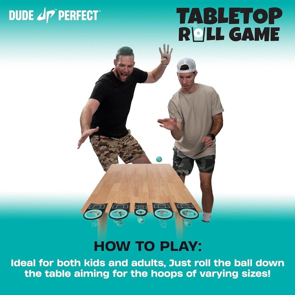 Two men playing a Tabletop Roll Game. One rolls a blue ball down a wooden ramp toward hoops, the other reacts