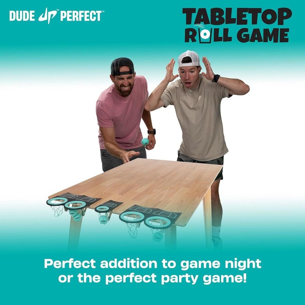 Two men play the Dude Perfect tabletop roll game. One rolls a ball towards hoops, the other reacts excitedly