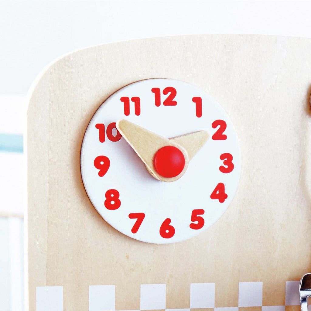 Wooden toy kitchen clock with large red numbers and natural wood hands