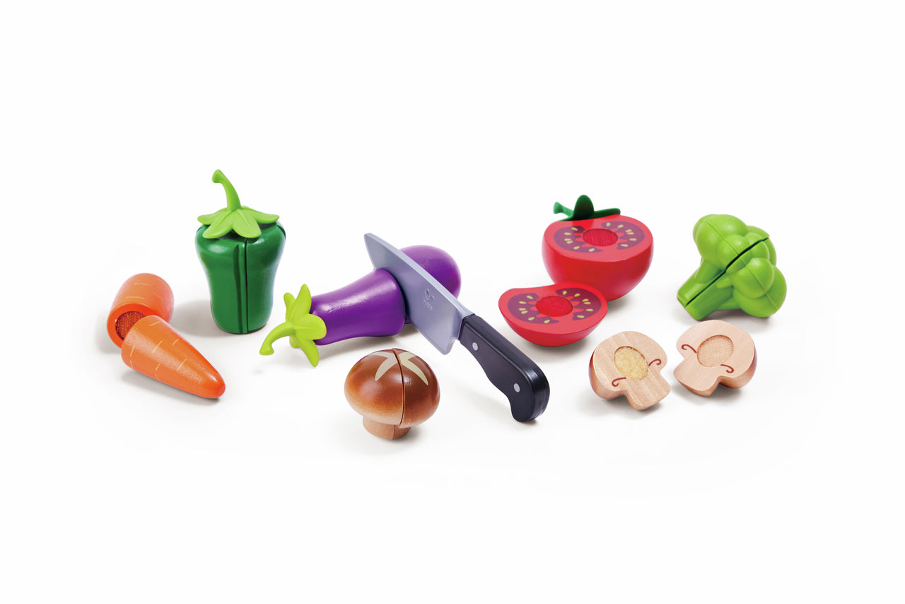 Play food set: colorful toy vegetables (eggplant, tomato, broccoli) being sliced by a toy knife