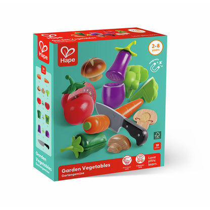 Box for Hape Garden Vegetables toy set, showing a knife and magnetic wooden produce, including carrot and tomato