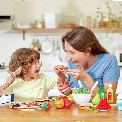 Joyful mother and child playing with wooden toy food in a kitchen, pretending to eat a slice of pizza