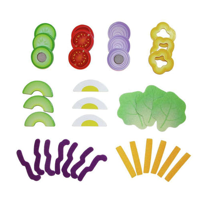 Flat lay of colorful wooden and felt play food slices: vegetables, eggs, and lettuce, on a white background