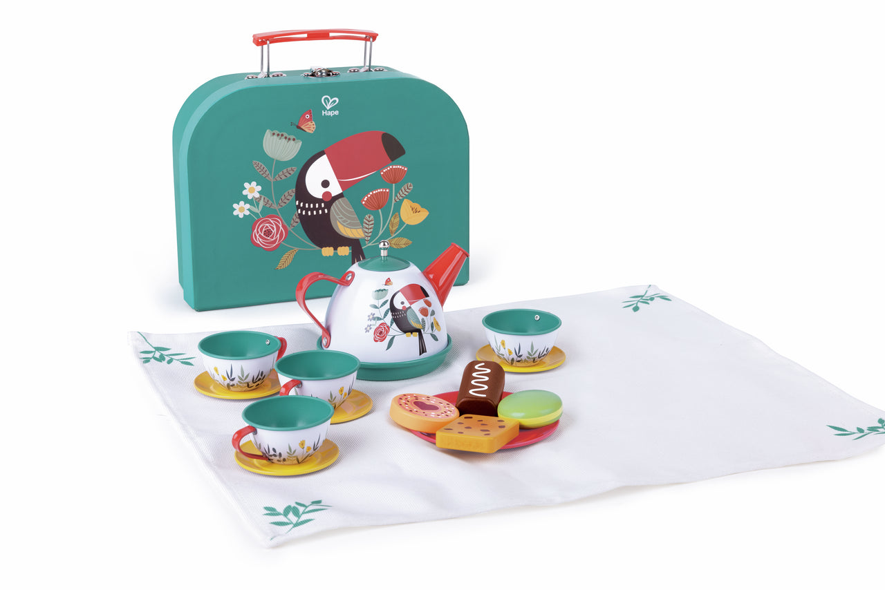 Hape toucan-themed toy tea set displayed with cups, teapot, wooden treats, and a teal carrying case