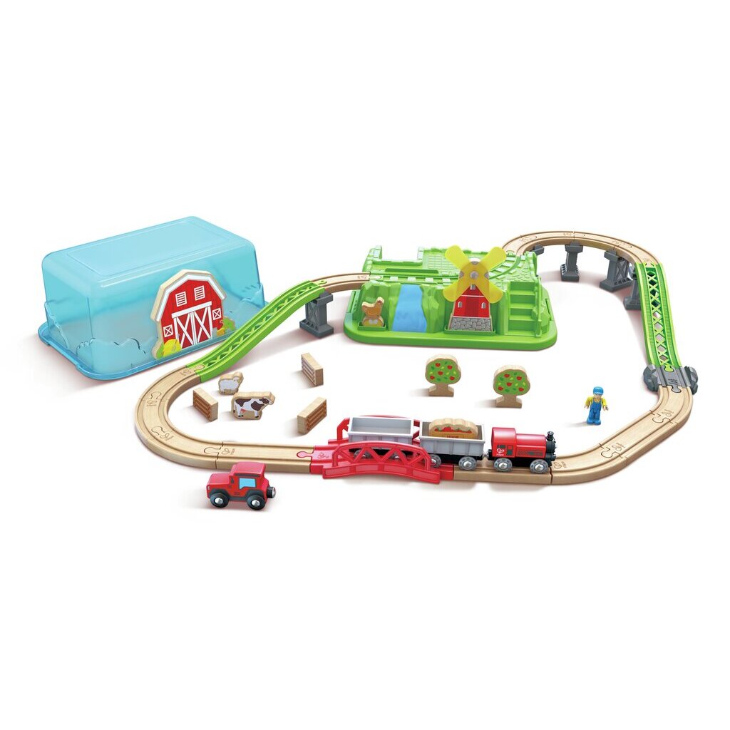 Farm-themed wooden toy train set with red engine, tracks, windmill structure, and barn storage box