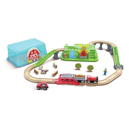 Farm-themed wooden toy train set with red engine, tracks, windmill structure, and barn storage box