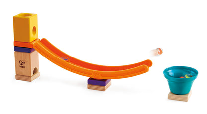 Colorful wooden block marble run with an orange track launching a marble toward a teal cup