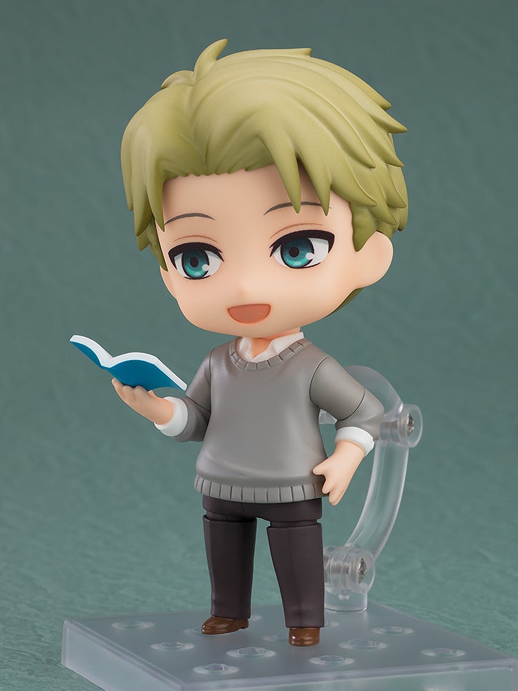 Loid Forger Nendoroid figure with blond hair, blue eyes, wearing a gray sweater, holding a small blue book