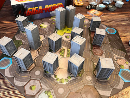 A Giga-Robot board game setup with numerous grey miniature skyscraper buildings on a hexagonal city map
