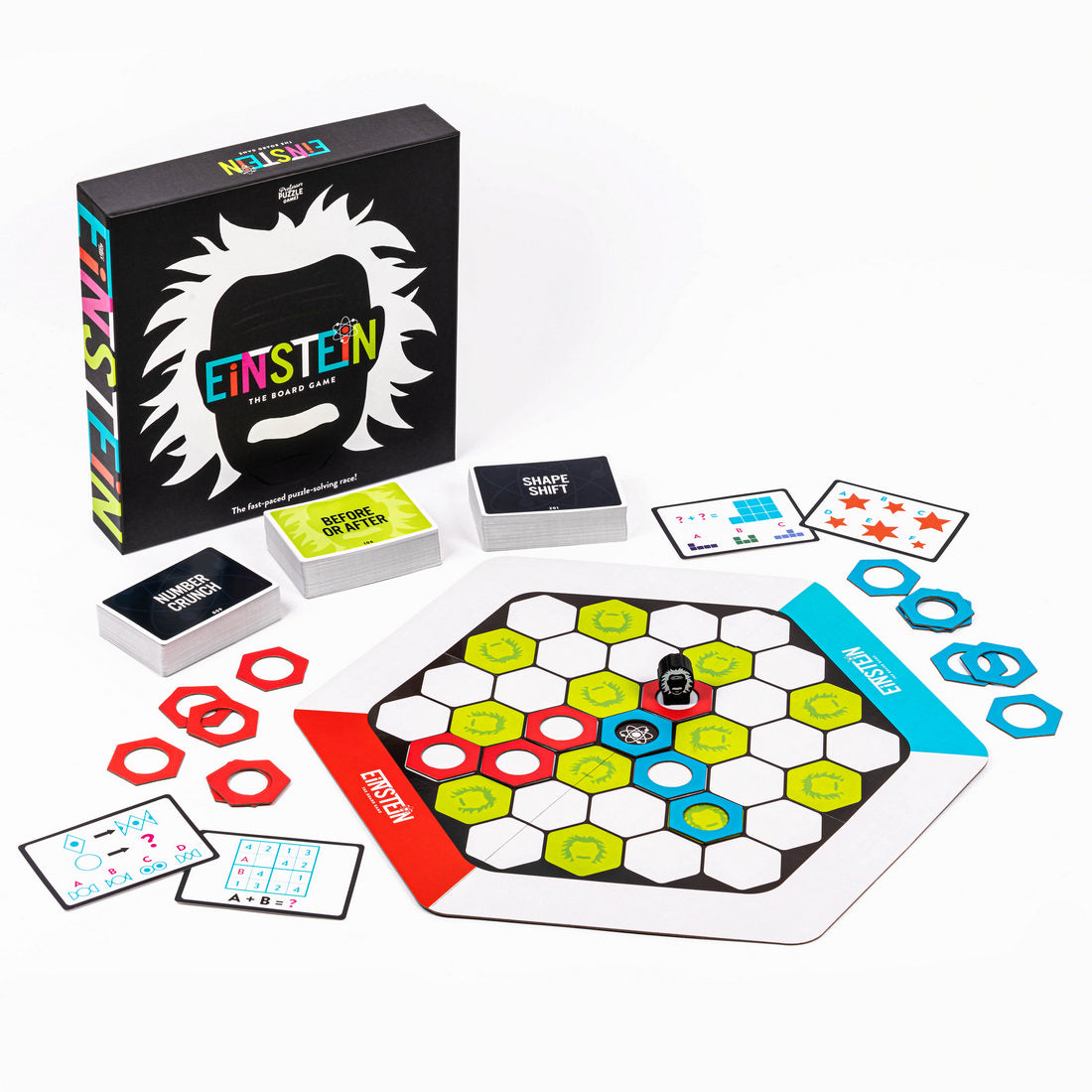 The Einstein board game components displayed, including the hexagonal board, puzzle cards, tokens, and black box