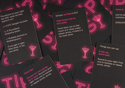 Pile of black game cards with neon pink martini glass icons and text for a drinking game