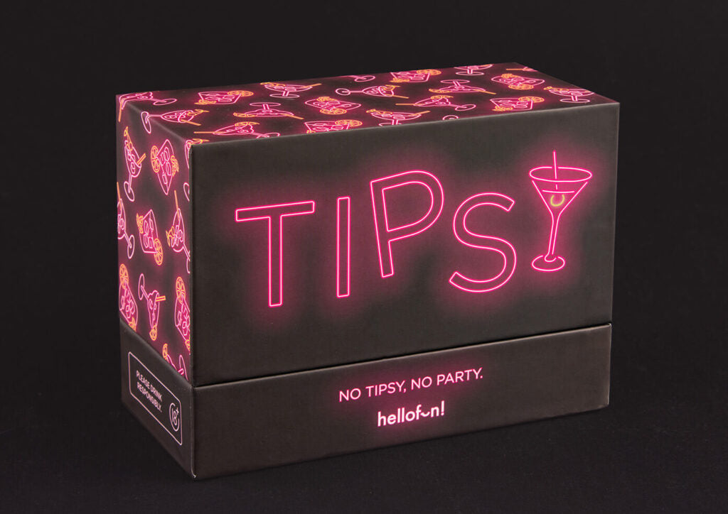 A dark "TIPSY" card game box features neon pink text, a martini glass 'Y', and cocktail patterns