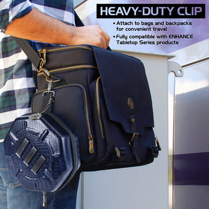 Person carries a dark blue bag with a smaller, textured hexagonal case attached via a heavy-duty clip