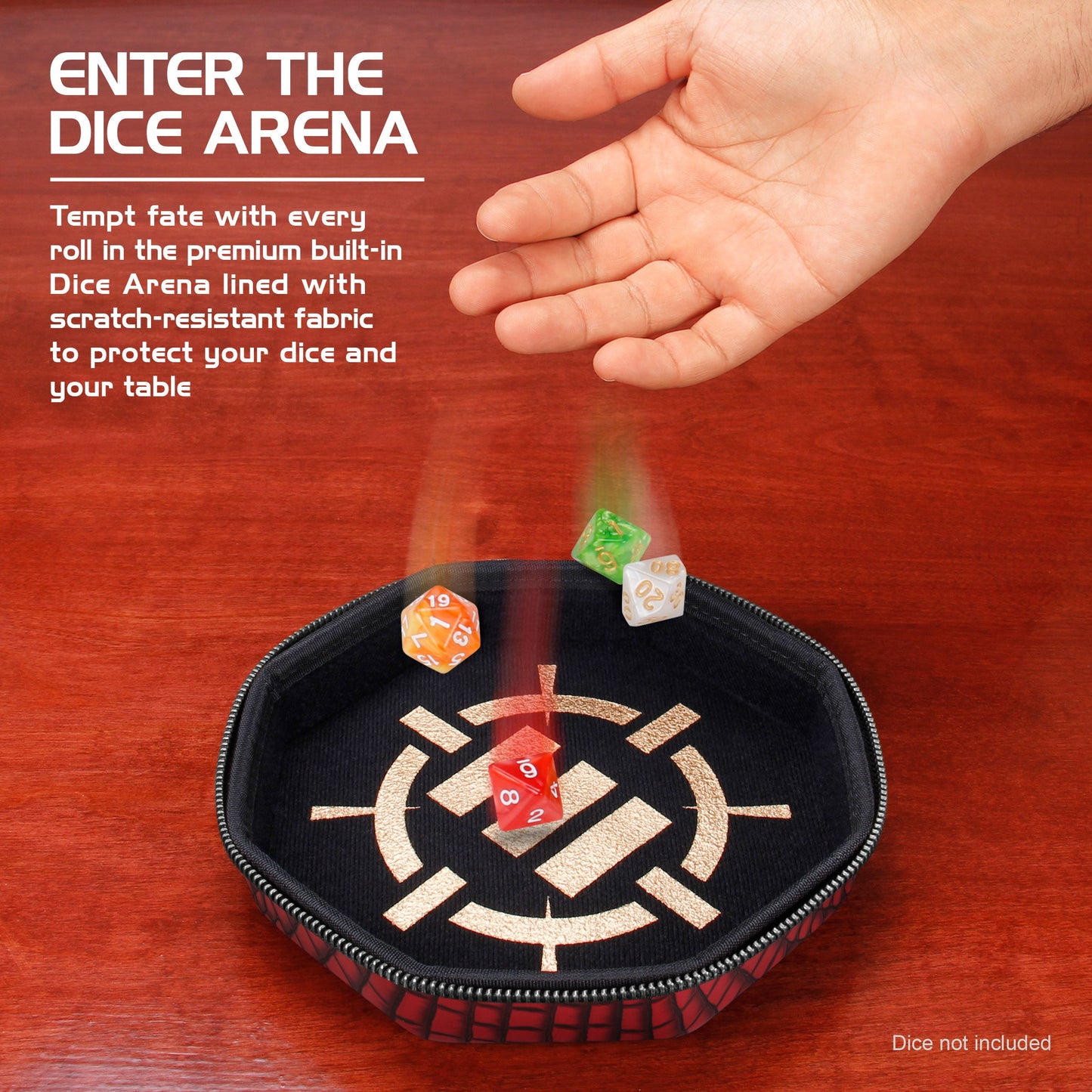 A hand drops colorful polyhedral dice into a black, gold-patterned dice tray on a wooden table
