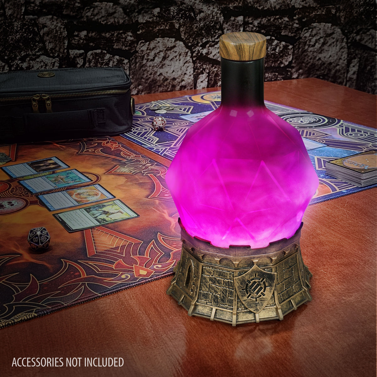 Glowing purple potion bottle lamp on a fantasy game mat with TCG cards, dice, and a deck case