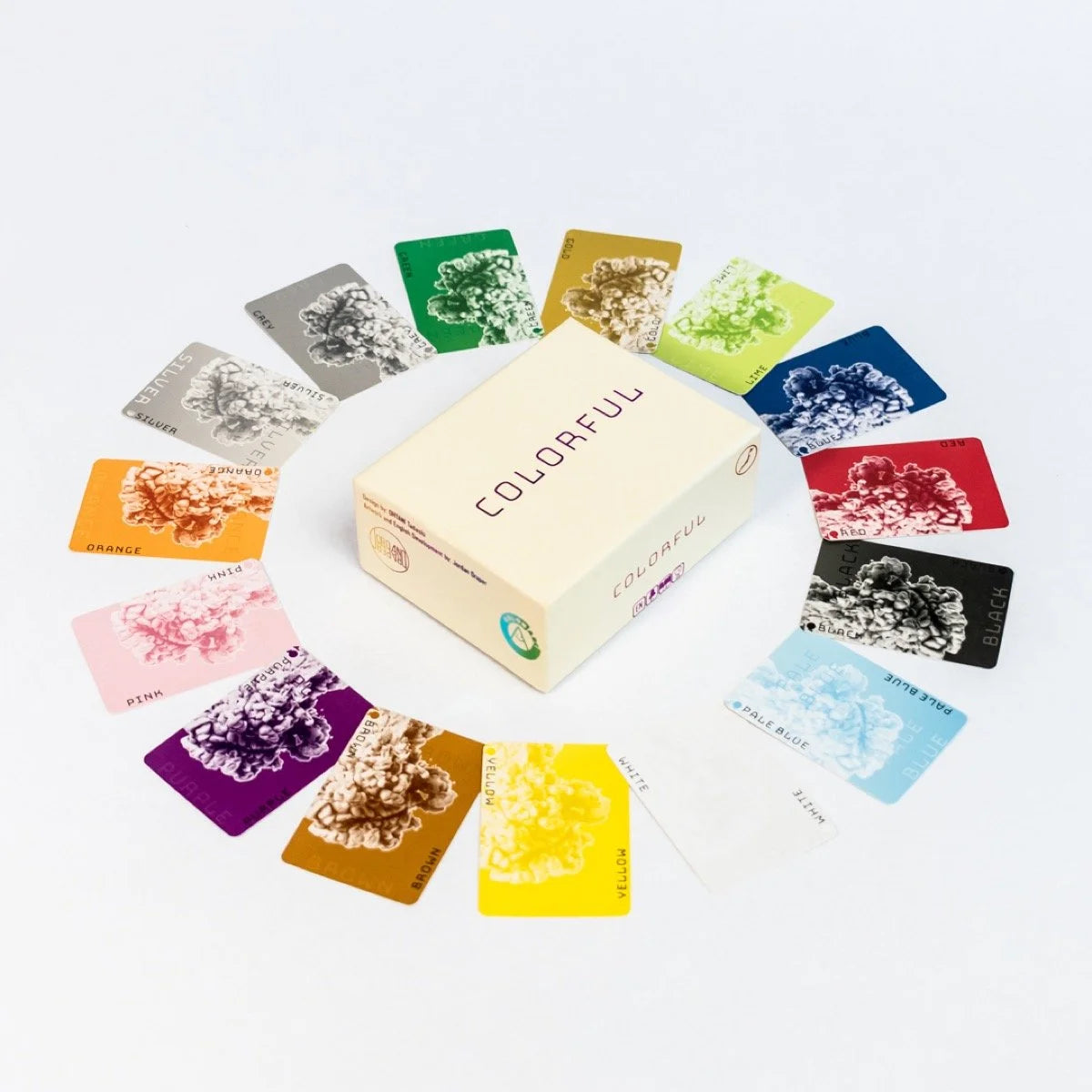 A box for the colourful Card Game is centered, surrounded by various coloured cards, each with a textured cloud design in its corresponding hue