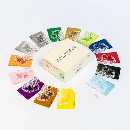 A box for the colourful Card Game is centered, surrounded by various coloured cards, each with a textured cloud design in its corresponding hue