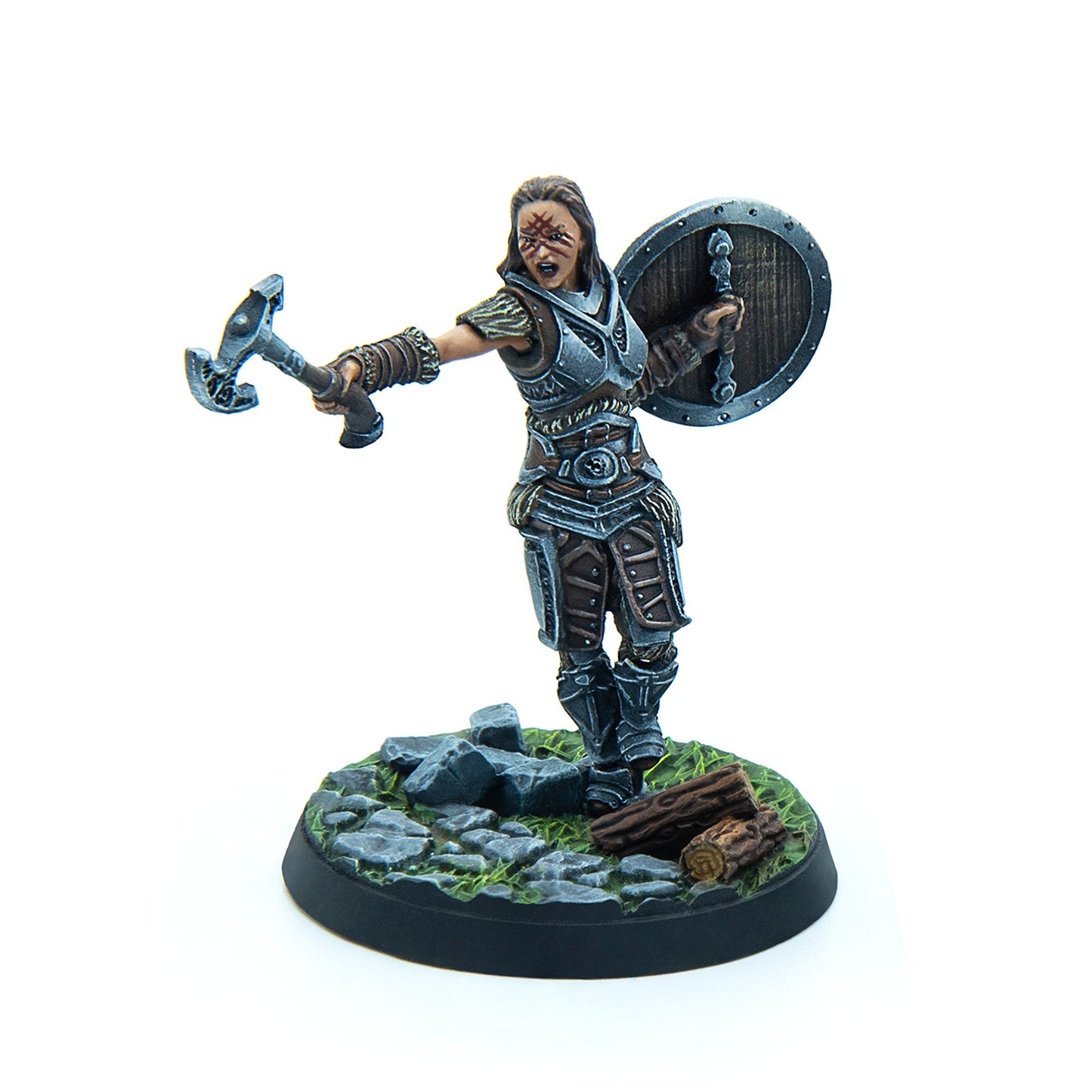 A miniature of a roaring female warrior in armor with war paint, holding an axe and shield on a scenic base