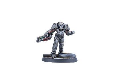 A grey armored miniature figure in power armor, holding a large sci-fi rifle, stands on a detailed base
